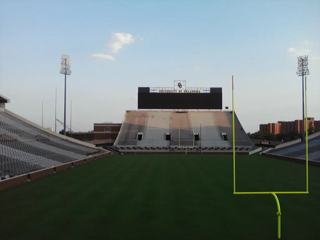 Commercial pressure washing service cleaning stadium bleachers and concrete seating in Norman OK - Daytime endzone perspective