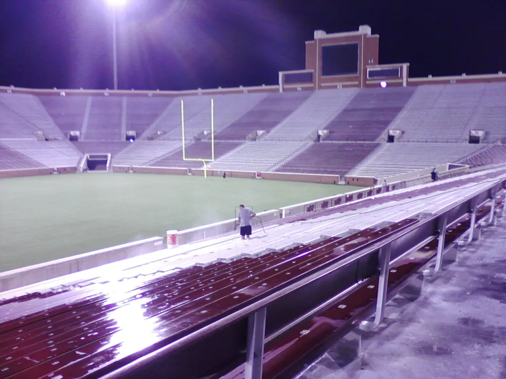 Commercial pressure washing service cleaning stadium bleachers and concrete seating in Norman OK - Lower bowl seating