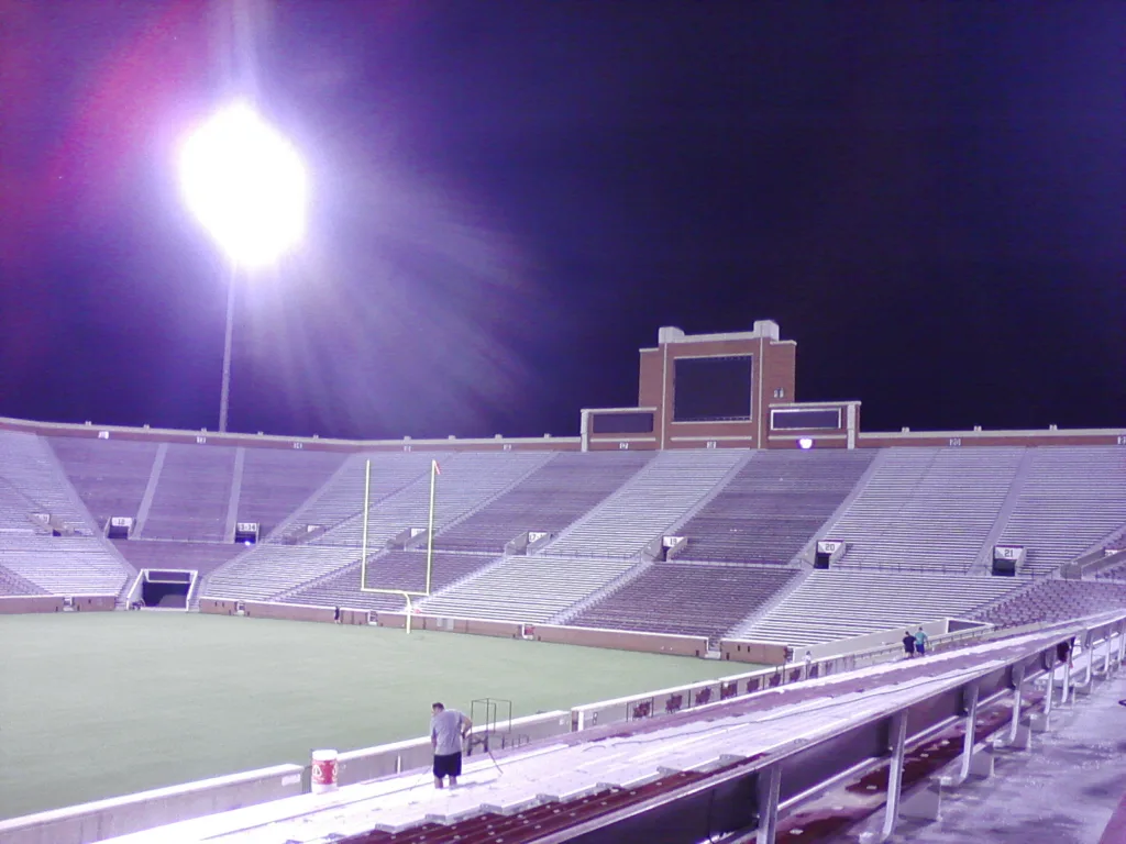 Commercial pressure washing service cleaning stadium bleachers and concrete seating - Wide endzone seating perspective