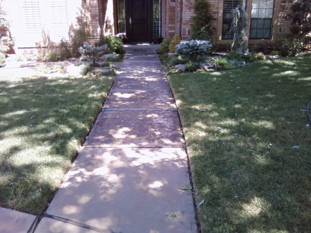 Residential pressure washing service cleaning concrete sidewalk in Norman Oklahoma Before