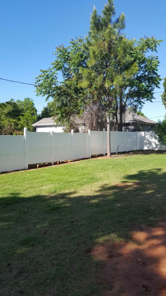 Soft wash vinyl fence cleaning service removing green algae stains - After clean result Norman OK