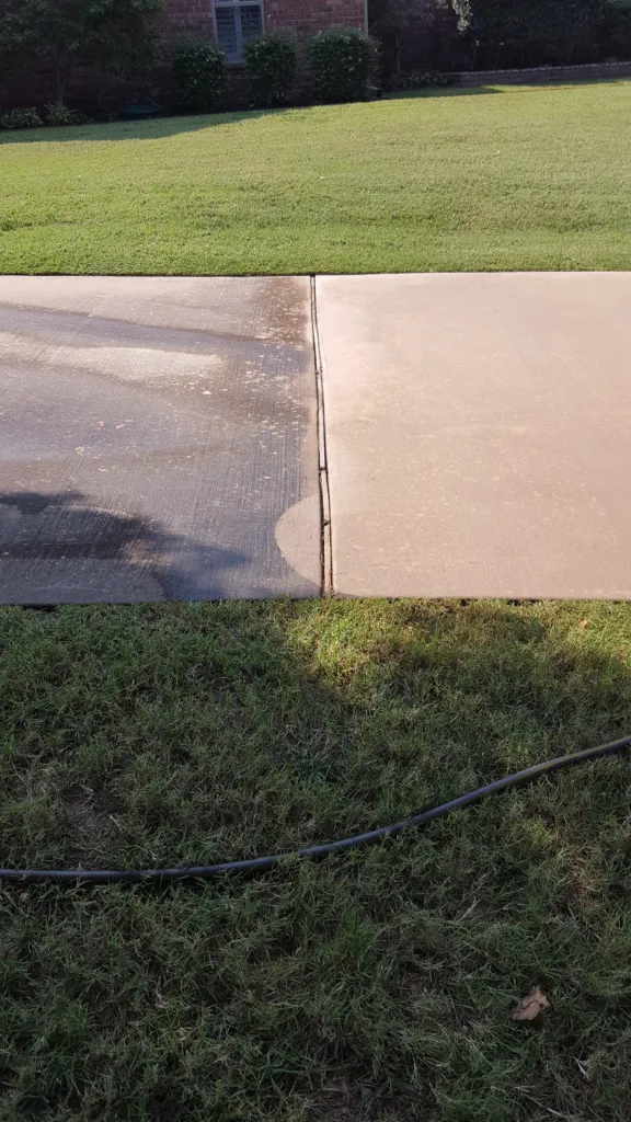 Residential pressure washing service cleaning concrete driveway in Edmond Oklahoma