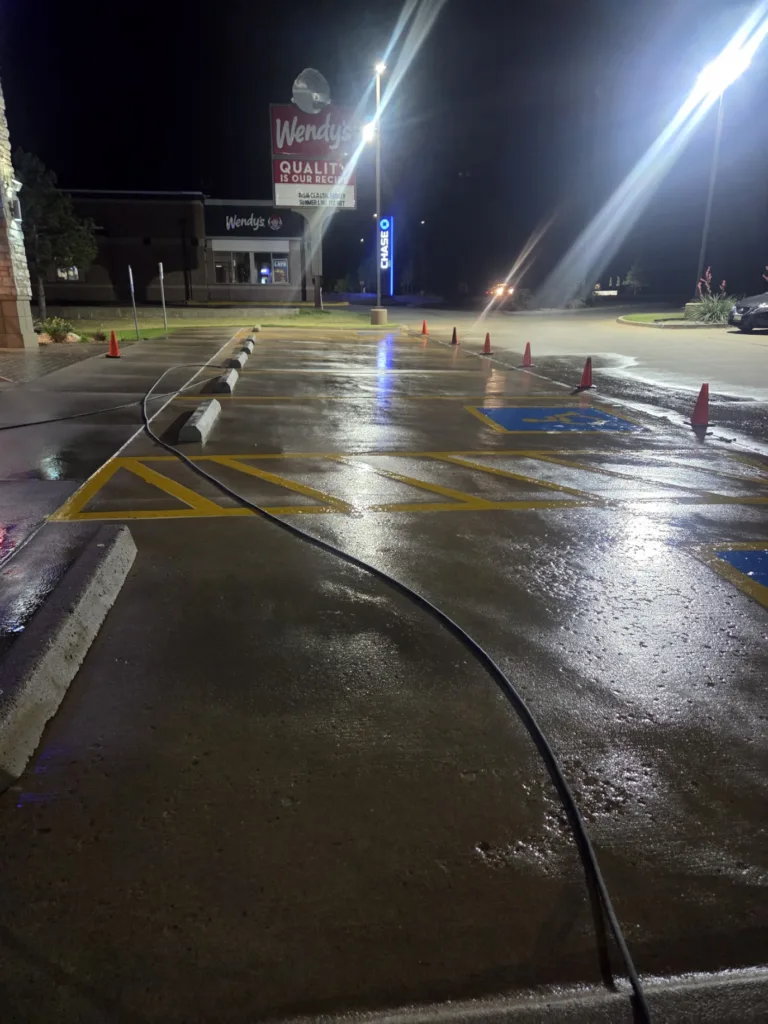 Commercial pressure washing service cleaning storefront parking lot and sidewalks