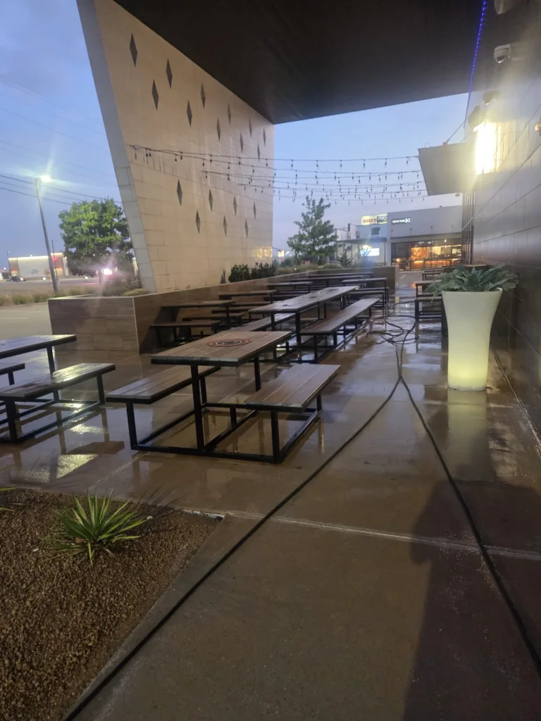 Professional pressure washing of commercial outdoor patio seating area in OKC