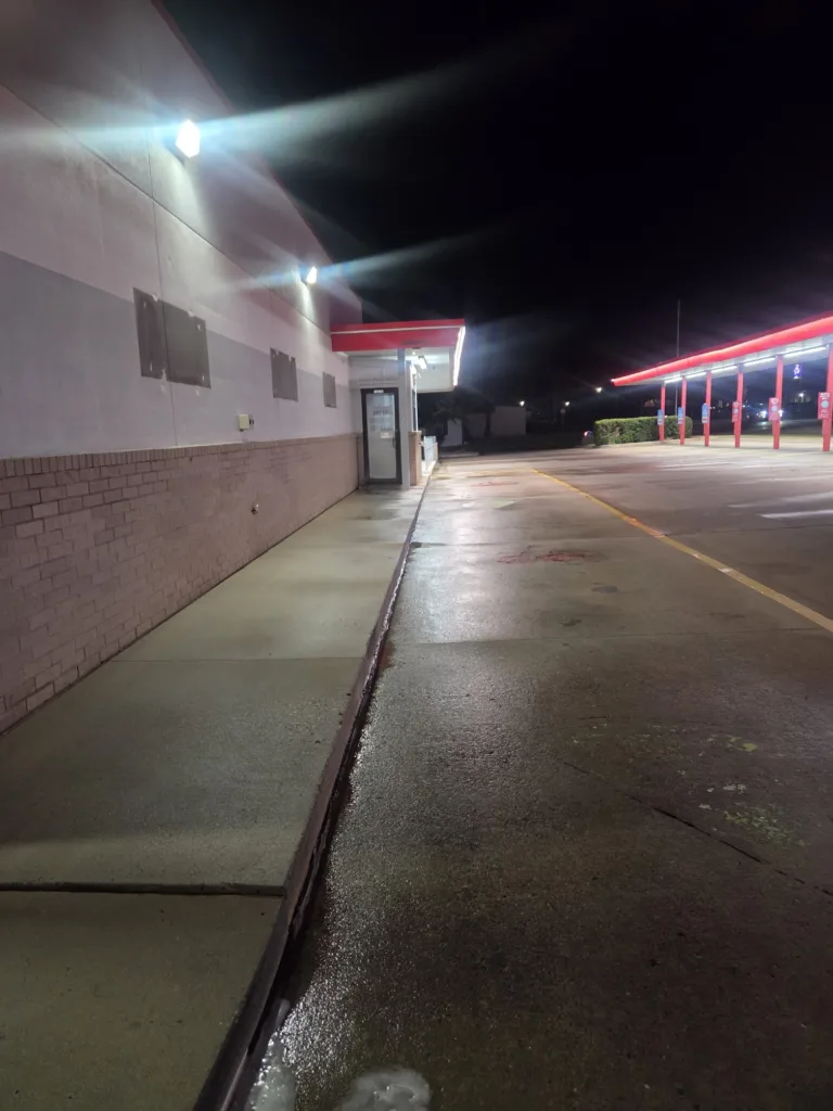 Commercial pressure washing service cleaning restaurant concrete sidewalks and drive-thru lanes