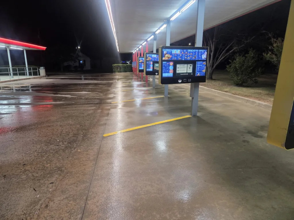 Commercial pressure washing service cleaning fast food drive-in stalls and concrete