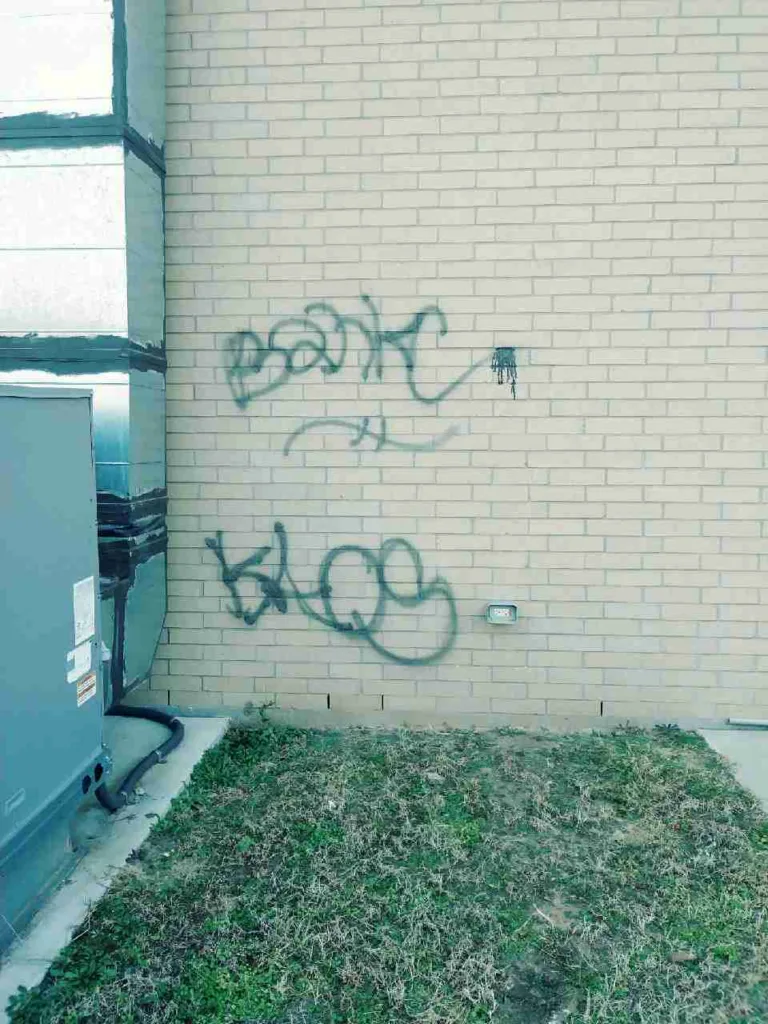 Graffiti removal service cleaning spray paint off brick wall in Oklahoma City OK - Before transformation