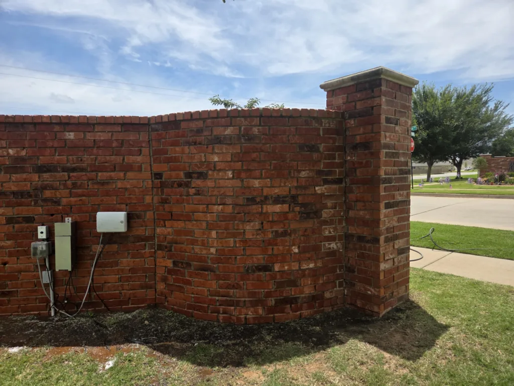 Graffiti removal service cleaning spray paint off brick wall - After