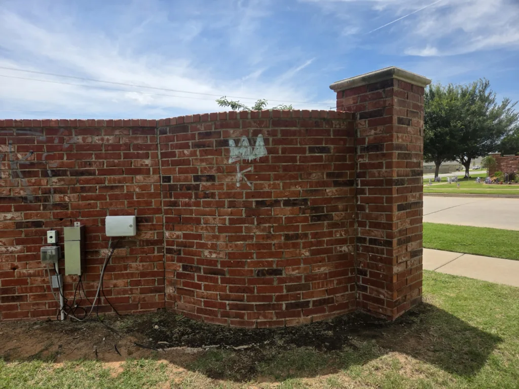 Graffiti removal service cleaning spray paint off brick wall - Before