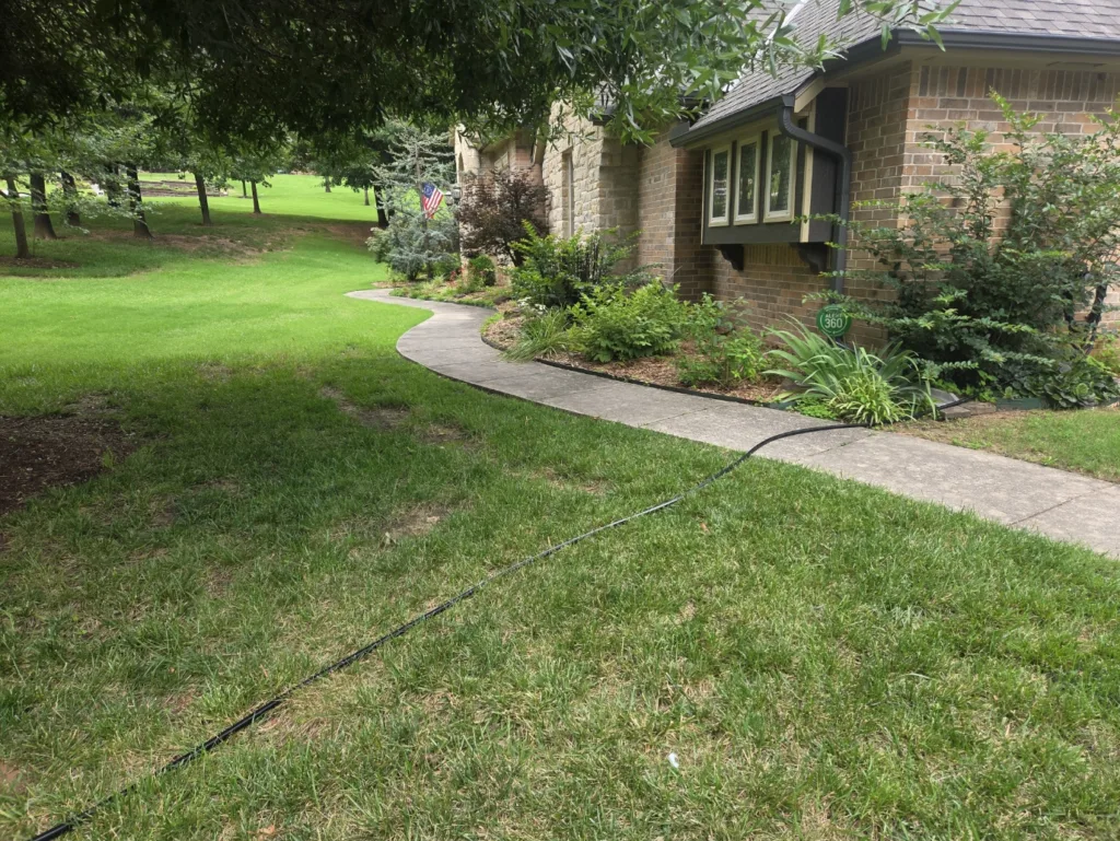 Residential pressure washing service cleaning concrete sidewalk in Choctaw Oklahoma Before